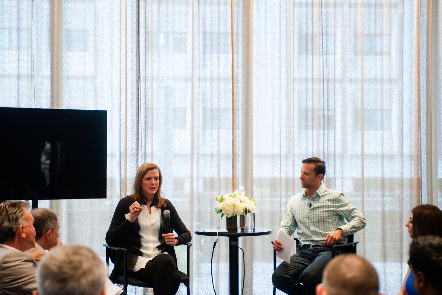 Mike Mudrey in a fireside conversation on stage at an executive gathering